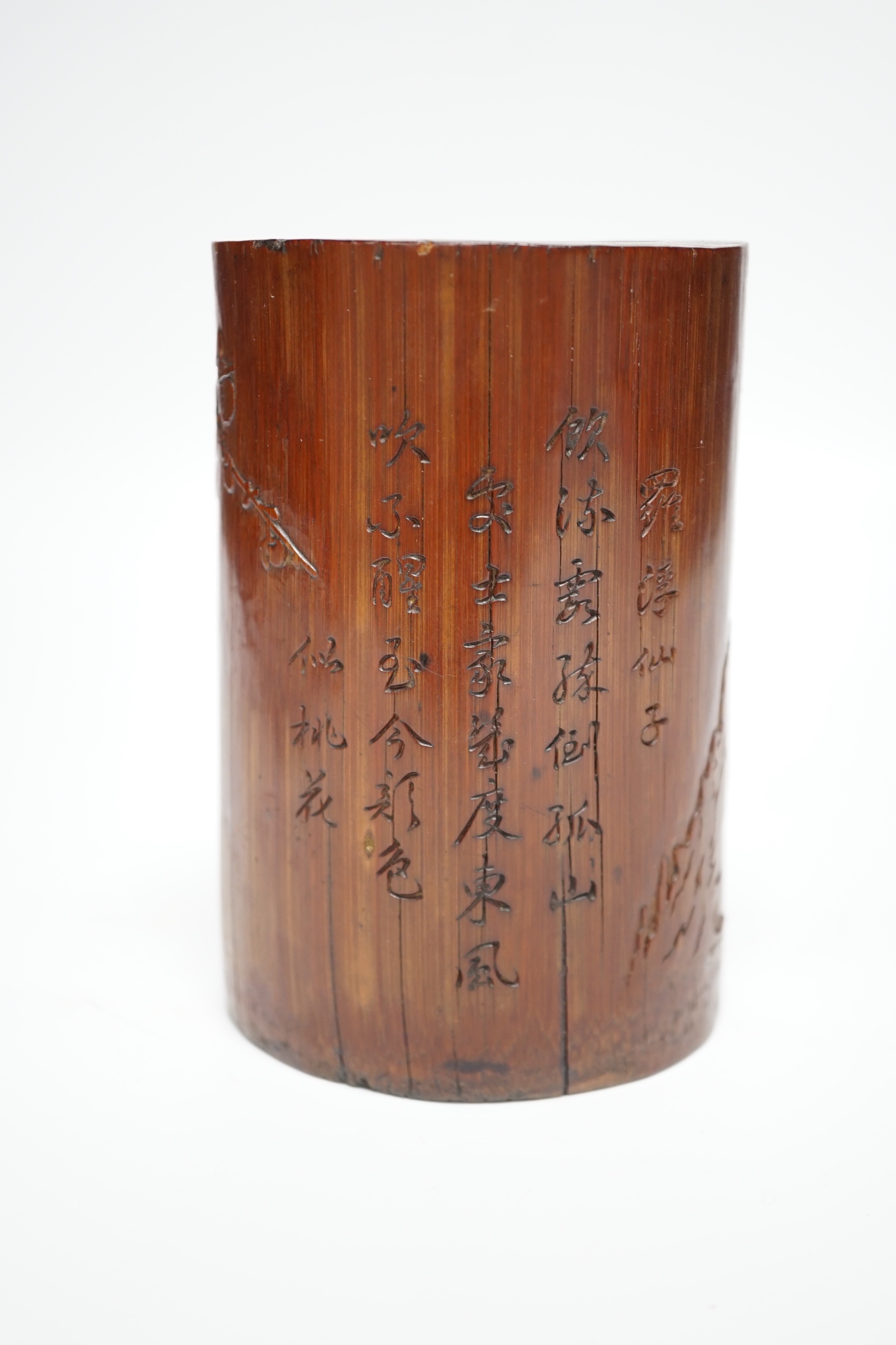 A 19th century Chinese Daoist bamboo brushpot, inscribed with a poem, 13cm high